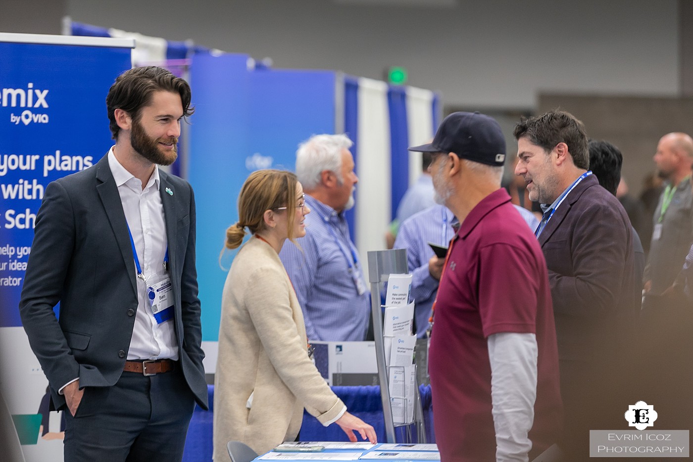 APTA Trade Show Vendor is Talking with Attendees by Portland Convention Photographer